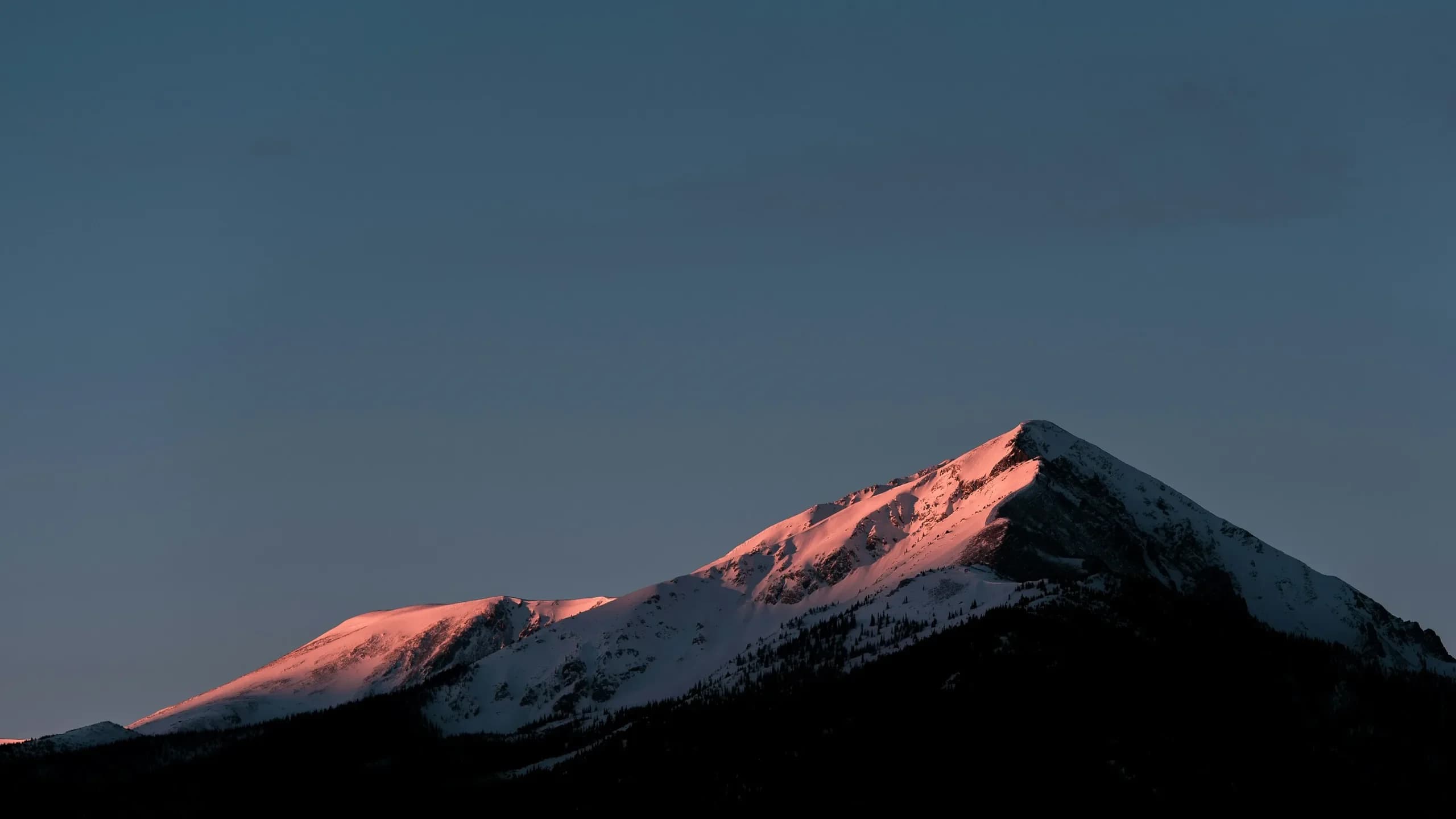 Last sunlight across the mountain peaks above Silverthorne, Colorado